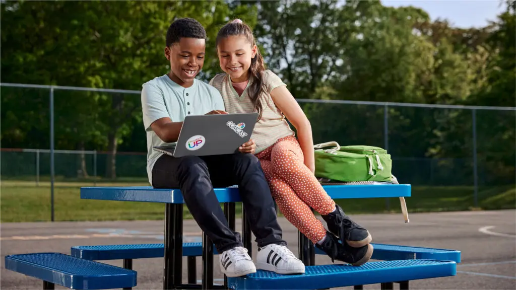 Students looking at laptop for online learning.