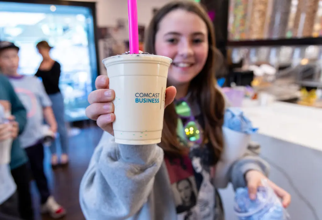 Young lady enjoying a local treat from Comcast Business.