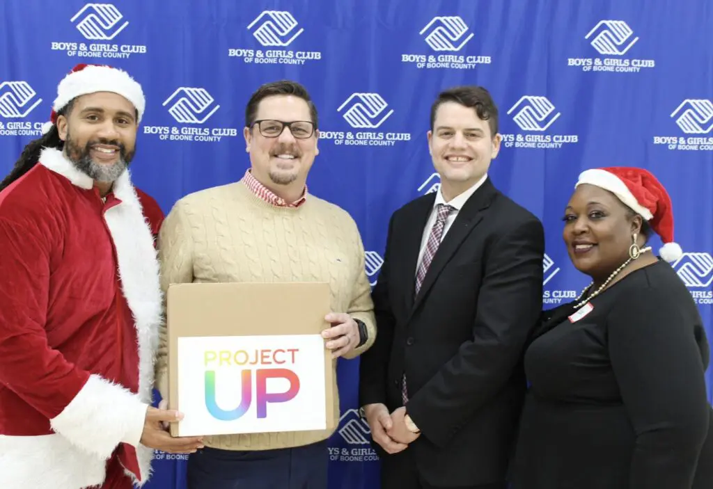 Boys & Girls Club Leadership are presented a laptop from Comcast and Santa.