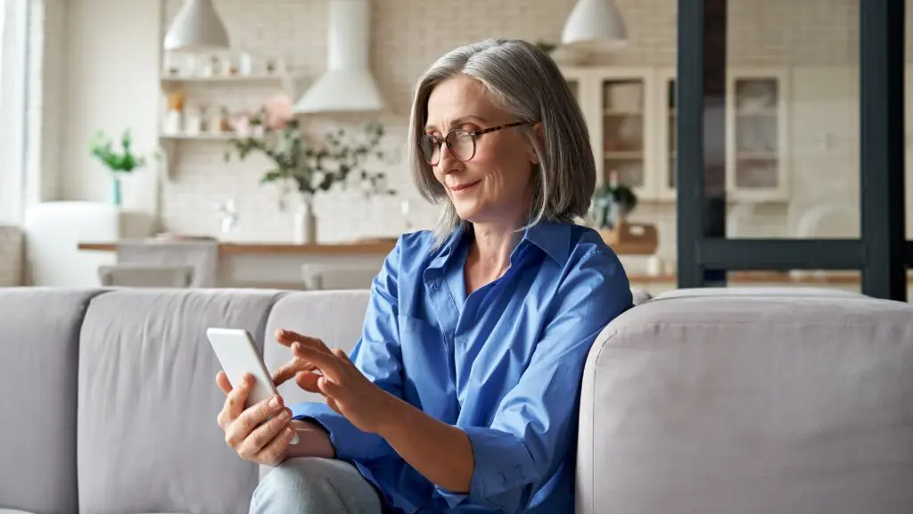 Woman spring cleaning apps on phone