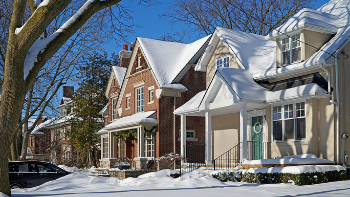 A row of houses covered in snow.