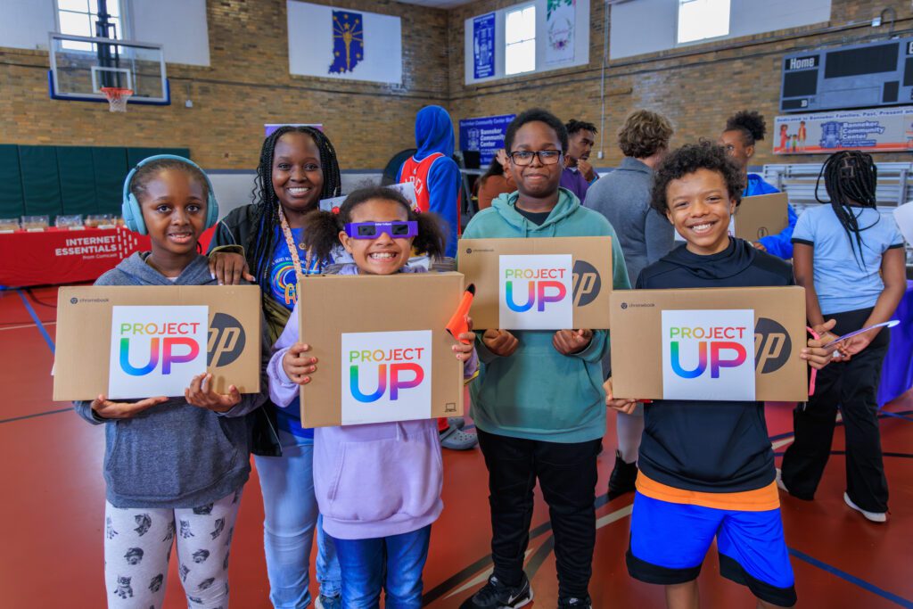 Bloomington residents receive laptops from Comcast, United Way of South Central Indiana, and Bloomington Mayor Kerry Thomson at the Banneker Community Center. 