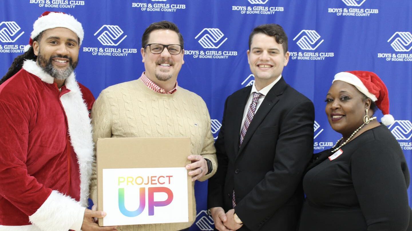 Boys & Girls Club Leadership are presented a laptop from Comcast and Santa.